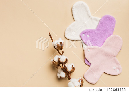set of colorful bright reusable menstrual pads with cotton flower. zero waste woman periods concept top view with copy space 122863333