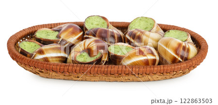 escargot snail filled with garlic and parsley butter in wicker basket isolated on white background 122863503