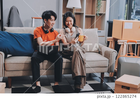 Smiling couple unpacking boxes in new house Smiling couple unpacking boxes in new house 122865274