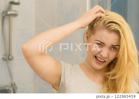 Female having problem with blonde hair 122865459