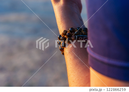 Muslim rosary beads on a man's hand. brown bead bracelet 122866259