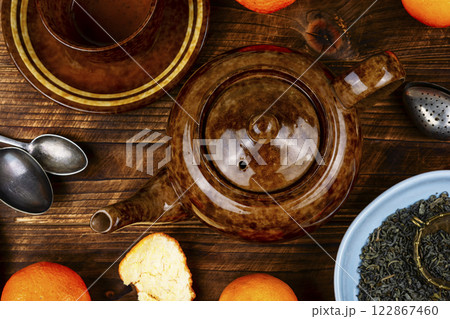 Tea pot with clementines. 122867460