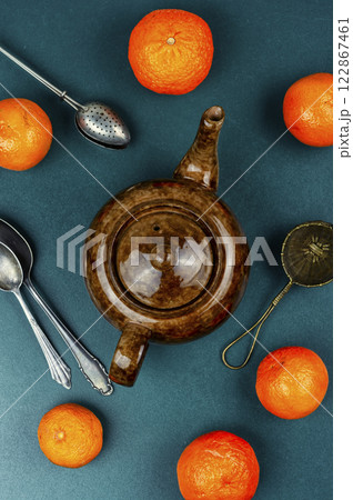 Glass kettle of tangerines tea. 122867461