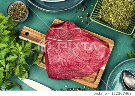 Raw red meat cuts on cutting board. Raw red meat cuts on cutting board. 122867462