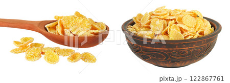 Cornflakes in wooden spoon and ceramic bowl isolated on white background. Cornflakes in wooden spoon and ceramic bowl isolated on white background. 122867761