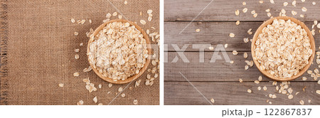 Oat flakes in a wooden bowl on sackcloth with copy space for your text. Top view 122867837