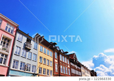 Nyhavn district in Copenhagen, Denmark. City center panoramic view of colorful houses. Nyhavn district in Copenhagen, Denmark. City center panoramic view of colorful houses. 122868330