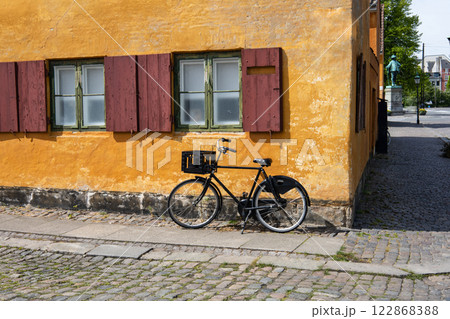 Beautiful view of old yellow houses in famous Nyboder district with a bikes. 122868388