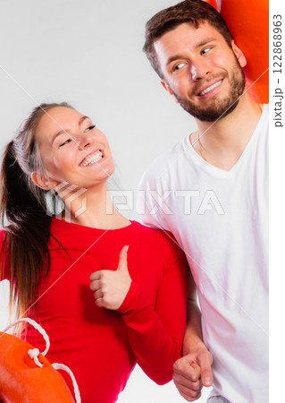 Happy lifeguard couple with equipment 122868963