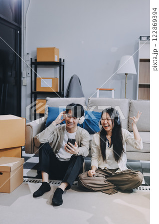 Smiling couple unpacking boxes in new house 122869394