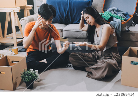 Young frustrated millennial couple sitting on couch at home, using computer and credit card. Buyers try to pay online have shortage of money on bank account. Extra expenses and big spender concept 122869414