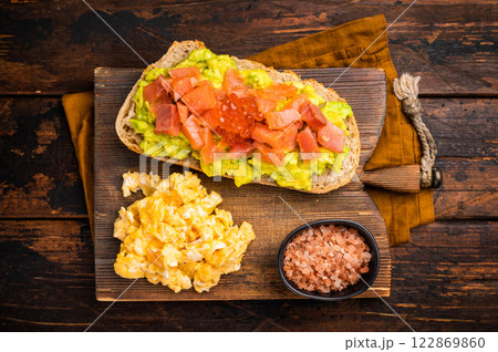 Sandwich with smoked salmon, trout, avocado and red caviar. wooden background. top view Sandwich with smoked salmon, trout, avocado and red caviar. wooden background. top view 122869860