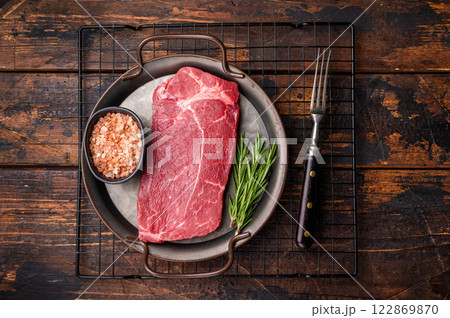 Ready for cooking Raw Rump beef steak with herbs. wooden background. top view 122869870