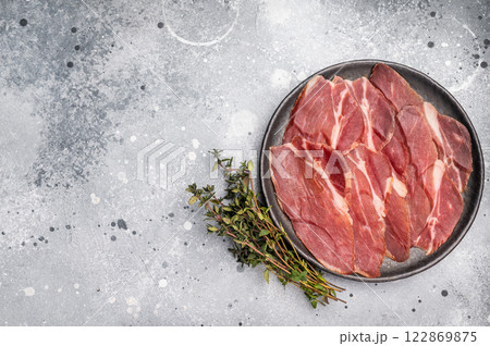 Slices of prsut, Balkan pork meat ham. grey background. top view Slices of prsut, Balkan pork meat ham. grey background. top view 122869875