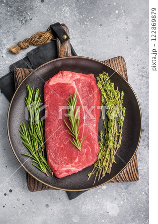 Raw Top sirloin beef steak with herbs. wooden background. top view 122869879