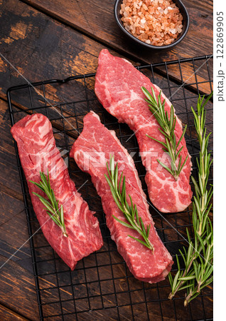 Raw Tri Tip Steak from Black Angus beef meat with rosemary. wooden background. top view 122869905