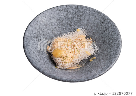 Uncooked dry glass noodles with spicy peanut dressing isolated on white background Uncooked dry glass noodles with spicy peanut dressing isolated on white background 122870077