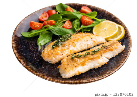 Roast Cod fish fiilets, white fish meat on plate with salad isolated on white background Roast Cod fish fiilets, white fish meat on plate with salad isolated on white background 122870102