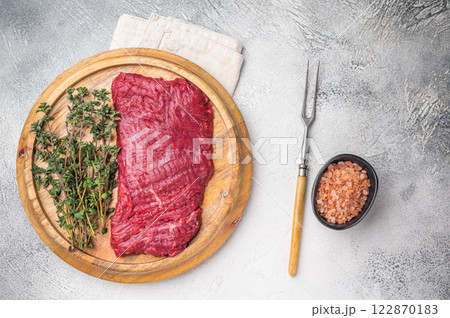 Flank steak, raw beef meat with herbs for frying. grey background. top view 122870183
