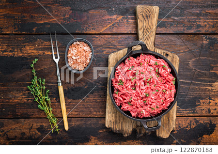 Veal beef raw mince meat, forcemeat in a skillet, on wooden background. Veal beef raw mince meat, forcemeat in a skillet, on wooden background. 122870188