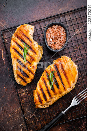 Eco Chicken grilled breasts, roasted poultry farm meat, top view, brown background. Eco Chicken grilled breasts, roasted poultry farm meat, top view, brown background. 122870216