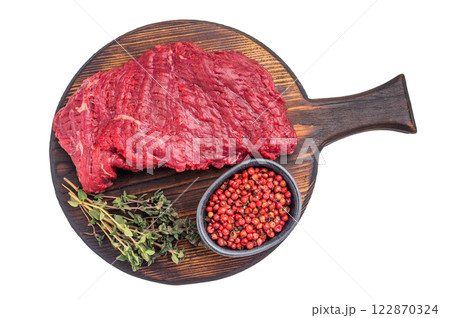 Flank or Flap steak, raw beef meat with thyme on wooden board isolated on white background. top view 122870324