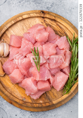 Diced raw turkey breast fillets, sliced poultry meat. grey background. top view 122870339