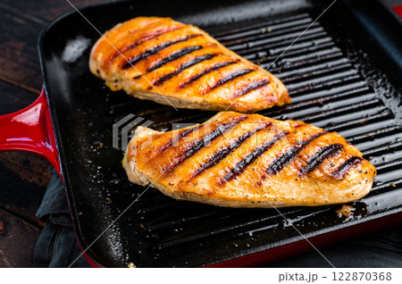 Roasted on grill pan Chicken breasts, fried poultry meat steaks, top view, wooden background. 122870368