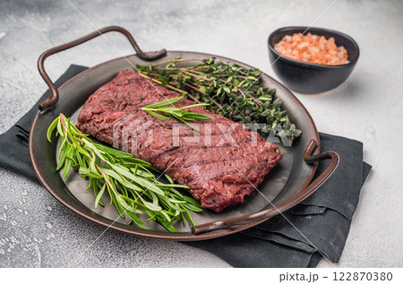 Grilled Flank or Flap steak, BBQ beef meat with thyme and spices on plate. grey background. top view 122870380