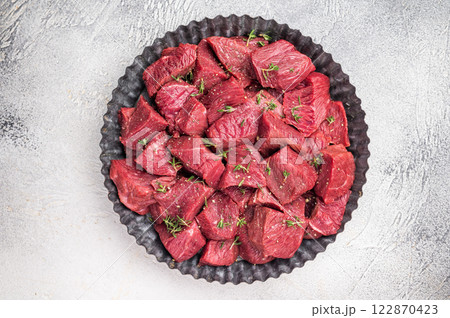 Ready for cooking Diced Raw kangaroo meat. white background. top view Ready for cooking Diced Raw kangaroo meat. white background. top view 122870423