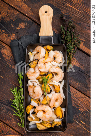 Seafood Cocktail appetiser with Mussels, Clams, Prawns, Shrimps and squid. wooden background. top view Seafood Cocktail appetiser with Mussels, Clams, Prawns, Shrimps and squid. wooden background. top view 122870433