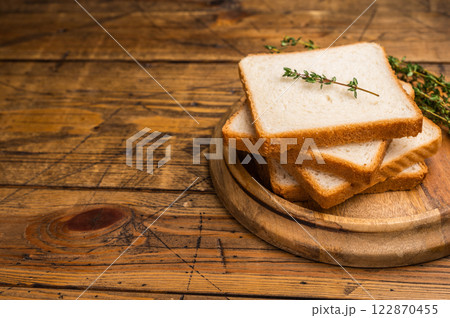 Ready for toasts Slices of wheat bread. wooden background. top view Ready for toasts Slices of wheat bread. wooden background. top view 122870455