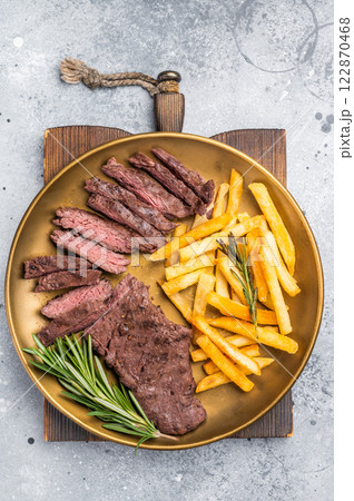 BBQ Grilled Beef Skirt Machete Steak on a plate with french fries grey background. top view 122870468