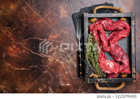 Beef cut Machete Skirt Steak, raw marble meat in wooden tray. black background. top view 122870480