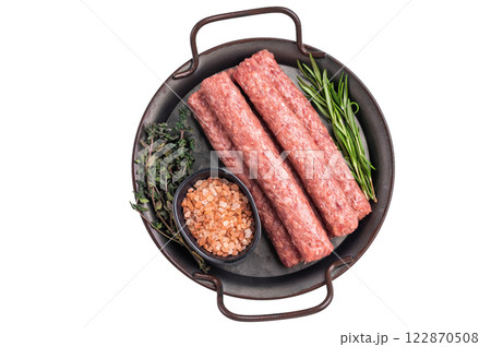 Raw Cevapcici ready for the grill, fresh Cevapi from mince beef meat isolated on white background. top view Raw Cevapcici ready for the grill, fresh Cevapi from mince beef meat isolated on white background. top view 122870508