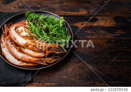 Seafood dinner with Grilled red Shrimps Prawns Langostino Austral on a plate with salad. wooden background. top view 122870538