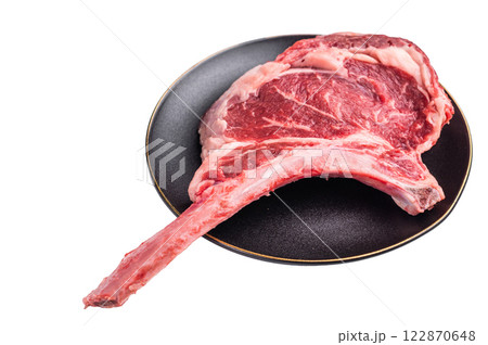 Fresh Tomahawk beef steak, raw marbled rib eye with bone on plate with herbs Isolated on a white background. top view Fresh Tomahawk beef steak, raw marbled rib eye with bone on plate with herbs Isolated on a white background. top view 122870648