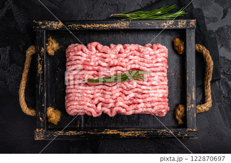 Fresh minced pork meat, raw mincemeat in wooden tray. black background. top view 122870697