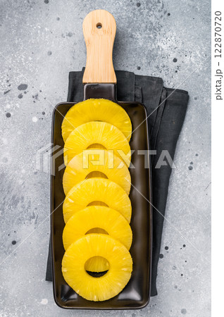 Canned Pineapple rings slices on a board. grey background. top view 122870720
