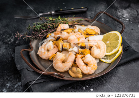 Fresh Seafood Mix with Mussels, Clams, Prawns, Shrimps and squid. black background. top view Fresh Seafood Mix with Mussels, Clams, Prawns, Shrimps and squid. black background. top view 122870733