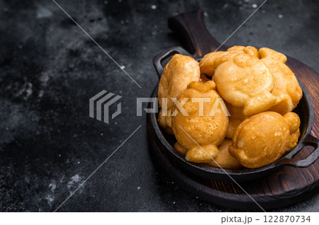 Korean winter snack Bungeoppang, Fish shaped Waffle with sweet filling. black background. top view Korean winter snack Bungeoppang, Fish shaped Waffle with sweet filling. black background. top view 122870734