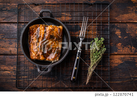 Teriyaki salmon fish fillet with glaze in a skillet. wooden background. top view Teriyaki salmon fish fillet with glaze in a skillet. wooden background. top view 122870741