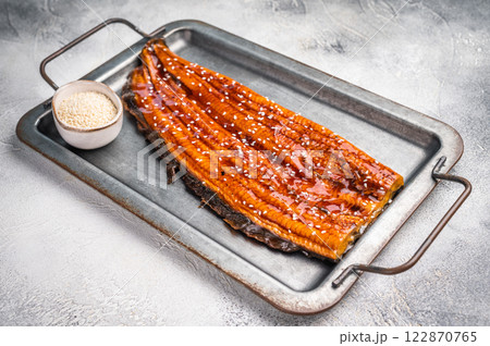 Unagi eel, grilled fish fillet with sauce. grey background. top view Unagi eel, grilled fish fillet with sauce. grey background. top view 122870765