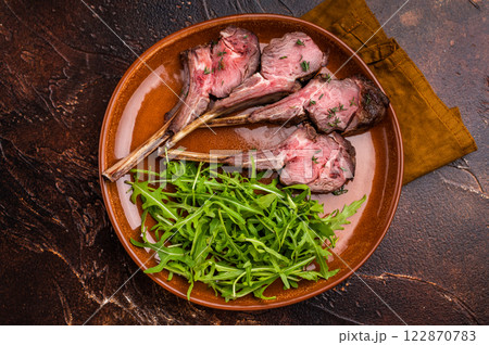 Roasted lamb chop cutlets, mutton meat steaks with salad. brown background. top view 122870783