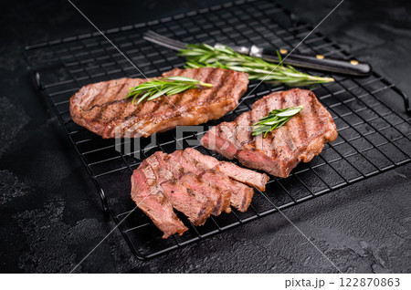 Grilled Top blade steak, shoulder beef meat. black background. top view Grilled Top blade steak, shoulder beef meat. black background. top view 122870863