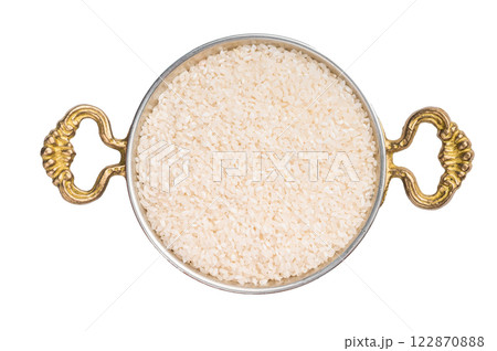 Uncooked white Rice in a bowl isolated on white background. top view Uncooked white Rice in a bowl isolated on white background. top view 122870888