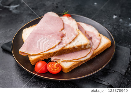 Ham sandwich, toast with sliced Prosciutto Cotto. black background. top view Ham sandwich, toast with sliced Prosciutto Cotto. black background. top view 122870940
