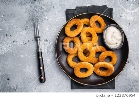 Fried squid rings, calamari seafood snack in a plate with deep. grey background. top view 122870954