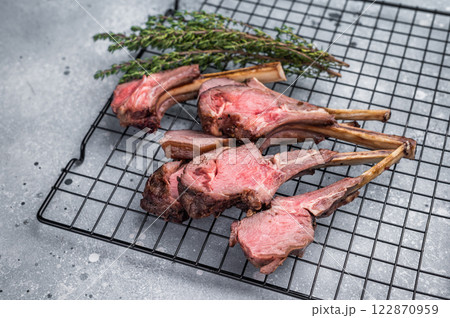 Roasted lamb chops steaks, mutton meat cutlets. grey background. top view Roasted lamb chops steaks, mutton meat cutlets. grey background. top view 122870959