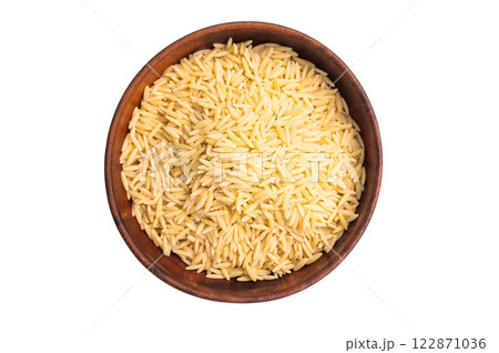 Raw Orzo pasta, uncooked dry Italian risoni in a bowl isolated on white background. top view Raw Orzo pasta, uncooked dry Italian risoni in a bowl isolated on white background. top view 122871036